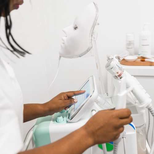 beautician-preparing-equipment-for-facial-rejuven-min beautician-preparing-equipment-for-facial-rejuven-min