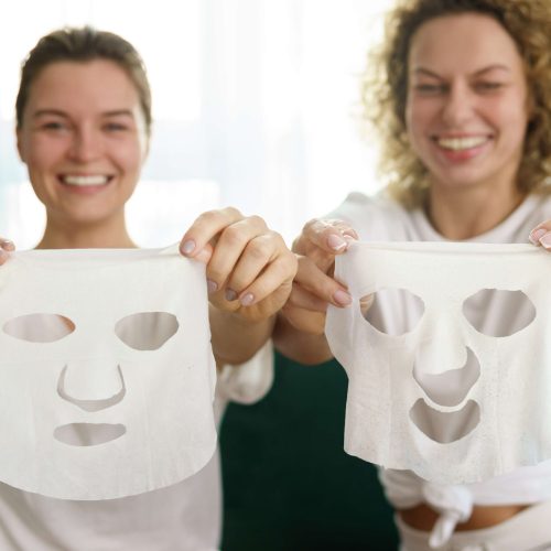 two-beautiful-and-cheerful-girls-with-a-sheet-mask two-beautiful-and-cheerful-girls-with-a-sheet-mask
